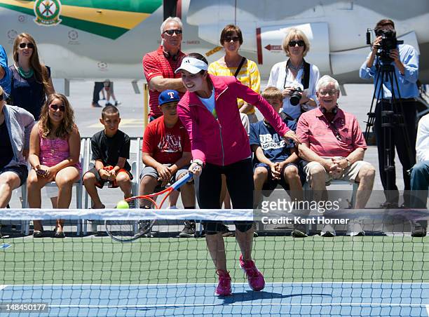 Player Christina McHale hits the ball while playing an exhibition tennis game on the flight deck aboard the floating musuem the USS Midway on July...