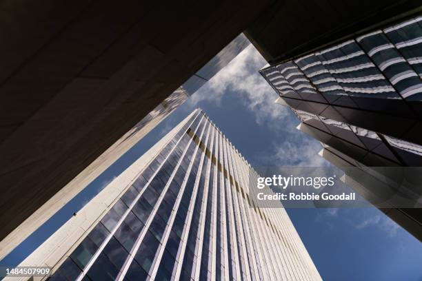 looking up at two skyscrapers towering over the city - australia economy stock-fotos und bilder