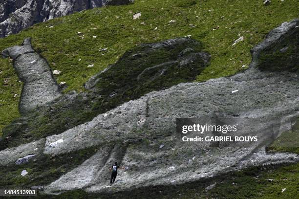 French Land artist Guillaume Legros aka "Saype" works on his new giant land art fresco entitled: "La Grande Dame" in Courmayeur, next to the Mont...