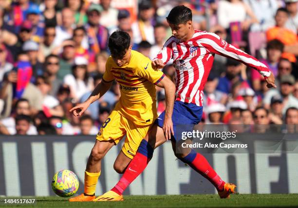 Pedri of FC Barcelona battles for possession with Alvaro Morata of Atletico Madrid during the LaLiga Santander match between FC Barcelona and...