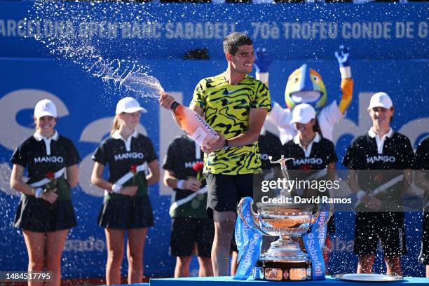 Carlos Alcaraz of Spain sprays champagne after beating Stefanos Tsitsipas of Greece during the Men's Singles Final on Day Seven of the Barcelona Open...
