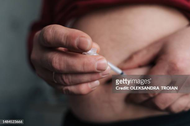 mature man belly close-up doing insulin shot, diabetes illness - injecting stomach stock pictures, royalty-free photos & images