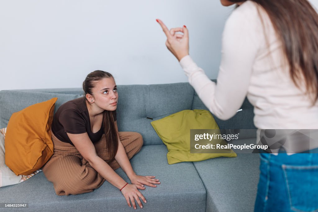 Mother Scolding Teenage Daughter in Living Room