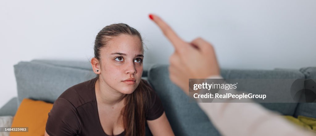 Mother Trying to Discipline Daughter in Living Room