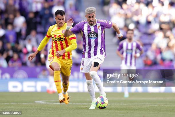 Kike Perez of Real Valladolid CF competes for the ball with Reinier Carvalho of Girona FC during the LaLiga Santander match between Real Valladolid...