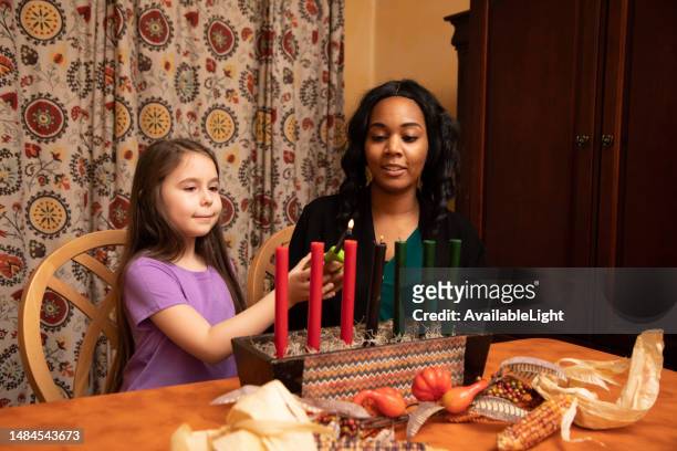 kwanzaa mom and daughter bond real - kwanzaa stock pictures, royalty-free photos & images