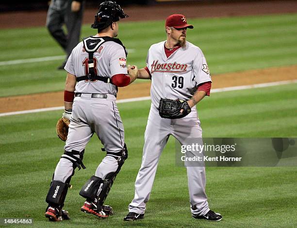 Pitcher Brett Myers of the Houston Astros is congratulated by catcher Chris Snyder recording the save by winning the game against the San Diego...