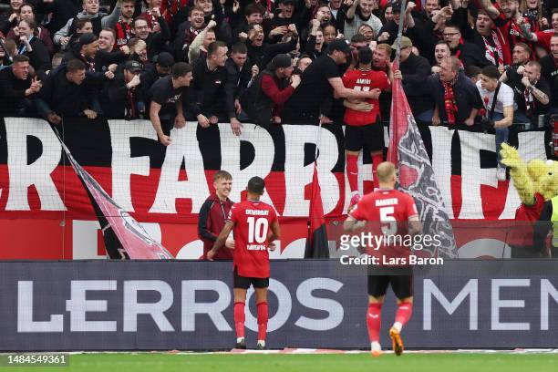Nadiem Amiri of Bayer 04 Leverkusen celebrates with the fans after scoring the team's second goal from the penalty spot during the Bundesliga match...