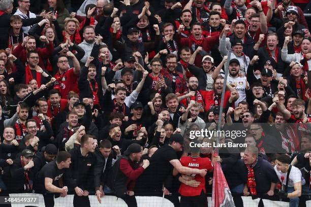 Nadiem Amiri of Bayer 04 Leverkusen celebrates with the fans after scoring the team's second goal from the penalty spot during the Bundesliga match...