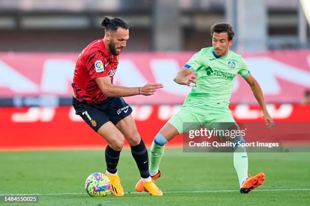 Vedat Muriqi of RCD Mallorca competes for the ball with Luis Milla of Getafe CF during the LaLiga Santander match between RCD Mallorca and Getafe CF...