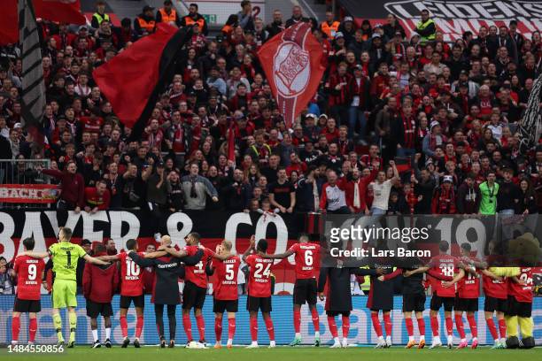 Bayer 04 Leverkusen players celebrate towards the fans after the team's victory in the Bundesliga match between Bayer 04 Leverkusen and RB Leipzig at...