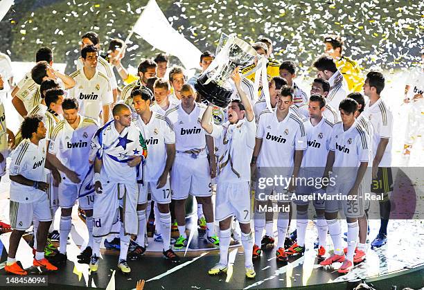 Cristiano Ronaldo of Real Madrid holds up the La Liga trophy as he celebrates with team-mates after the La Liga match between Real Madrid CF and RCD...