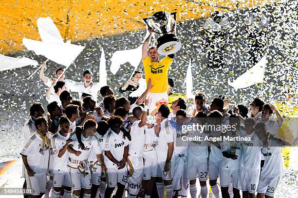 Iker Casillas of Real Madrid CF holds up the La Liga trophy as he celebrates with team-mates after the La Liga match between Real Madrid CF and RCD...