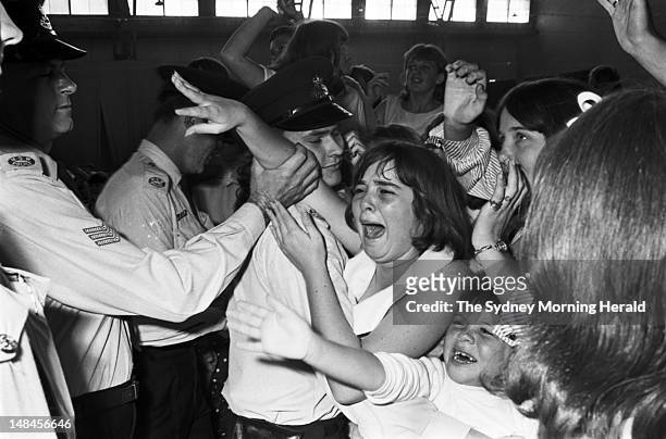 Policemen control the crowd of screaming fans at the Rolling Stones matinee concert at Sydney Showground, January 23 1965..