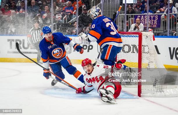 Sebastian Aho of the Carolina Hurricanes crashes into Ilya Sorokin of the New York Islanders during the second period in Game Four of the First Round...