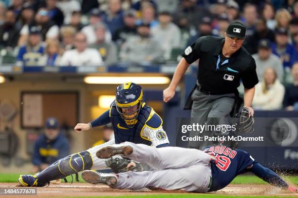 Alex Verdugo of the Boston Red Sox slides safely to home plate against Victor Caratini of the Milwaukee Brewers in the first inning at American...