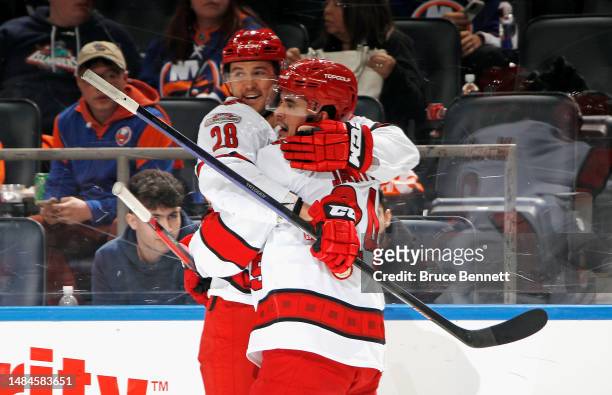 Seth Jarvis of the Carolina Hurricanes celebrates his goal at 1:20 of the third period against the New York Islanders and is joined by Mackenzie...