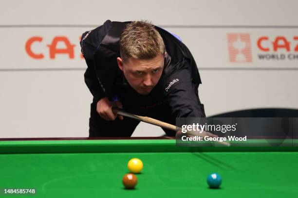 Kyren Wilson of England plays a shot during their round two match against John Higgins of Scotland on Day Nine of the Cazoo World Snooker...