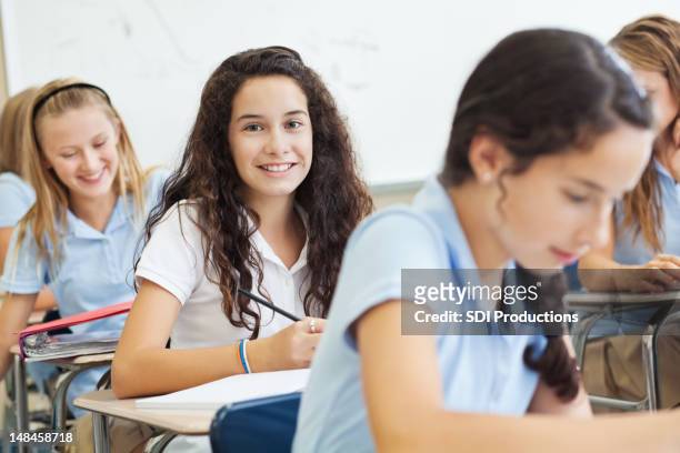 happy private school student smiling during test - independent school stock pictures, royalty-free photos & images