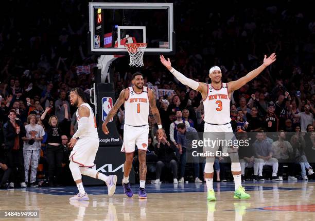 Josh Hart of the New York Knicks celebrates his shot with teammates Jalen Brunson and Obi Toppin in the fourth quarter against the Cleveland...