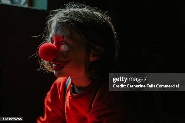a young child dressed up as a clown - big nose 個照片及圖片檔
