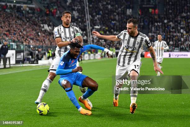 Andre-Frank Zambo Anguissa of SSC Napoli is challenged by Danilo and Federico Gatti of Juventus during the Serie A match between Juventus and SSC...