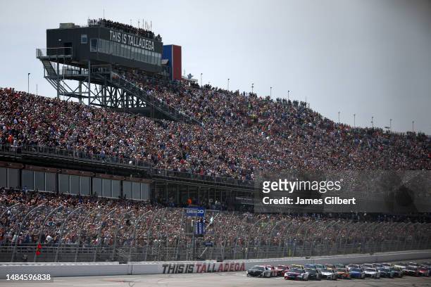 Denny Hamlin, driver of the FedEx Freight Direct Toyota, and Aric Almirola, driver of the Smithfield Ford, lead the field to the green flag to start...