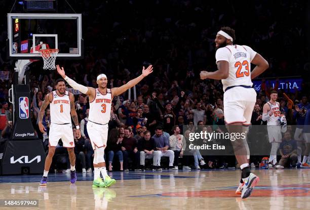 Obi Toppin,Josh Hart and Mitchell Robinson of the New York Knicks celebrate late in the fourth quarter against the Cleveland Cavaliers during Game...