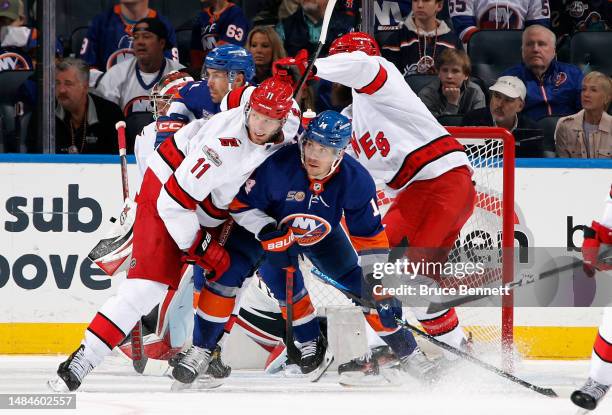 Bo Horvat of the New York Islanders is checked by Jordan Staal of the Carolina Hurricanes during the third period during Game Four in the First Round...