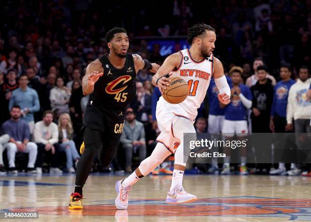 Jalen Brunson of the New York Knicks tries to keep the ball from Donovan Mitchell of the Cleveland Cavaliers in the fourth quarter during Game Four...