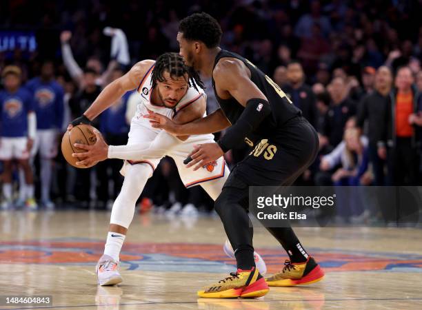 Jalen Brunson of the New York Knicks tries to keep the ball from Donovan Mitchell of the Cleveland Cavaliers in the fourth quarter during Game Four...