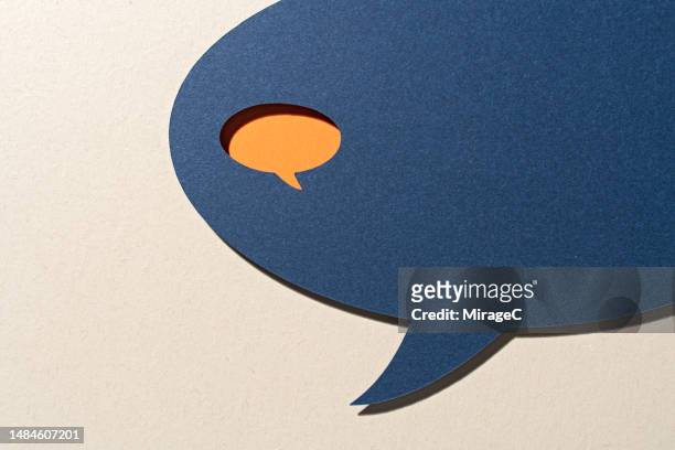 contrast of a small speech bubble inside a big speech bubble - exclusion concept stock pictures, royalty-free photos & images