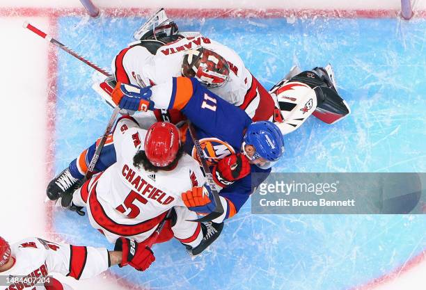 Jalen Chatfield of the Carolina Hurricanes moves Zach Parise of the New York Islanders from the crease during Game Four in the First Round of the...