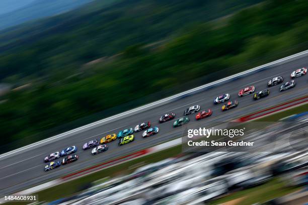 Chase Elliott, driver of the NAPA Auto Parts Chevrolet, and Alex Bowman, driver of the Ally Chevrolet, lead the field in the closing laps of stage...