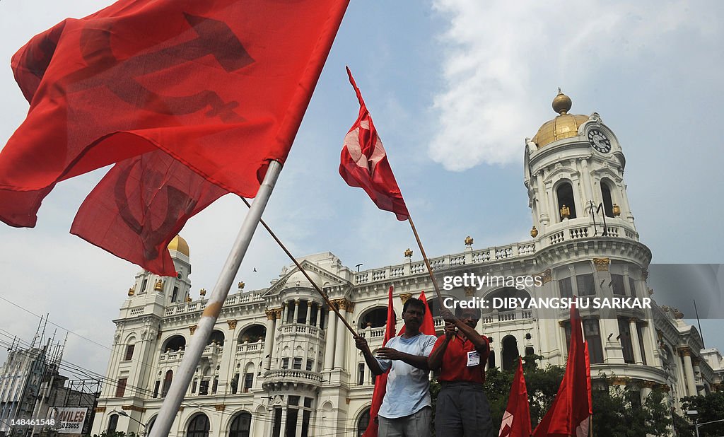 Leftist activists wave party flags during a protest rally in Kolkata ...