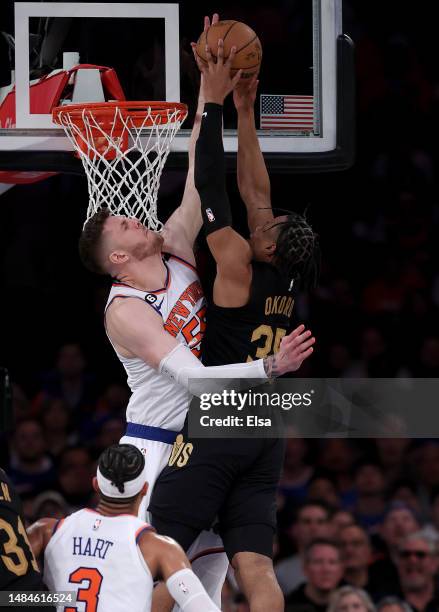 Isaiah Hartenstein of the New York Knicks blocks a shot by Isaac Okoro of the Cleveland Cavaliers in the second half during Game Four of the Eastern...