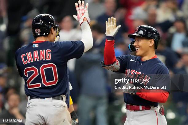 Masataka Yoshida of the Boston Red Sox celebrates with Yu Chang after hitting a grand slam in the eighth inning against the Milwaukee Brewers at...