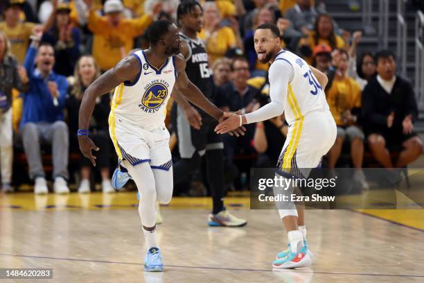 Stephen Curry congratulates Draymond Green of the Golden State Warriors after he made a basket against the Sacramento Kings during Game Four of the...