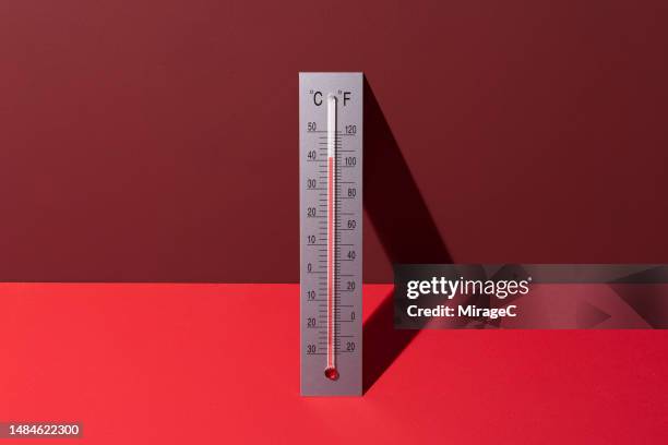 silver thermometer shows high temperature on red background - heatwave stock pictures, royalty-free photos & images