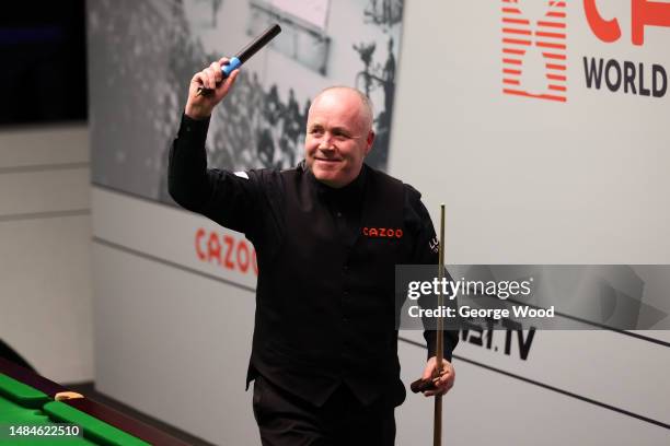 John Higgins of Scotland celebrates victory following their round two match against Kyren Wilson of England on Day Nine of the Cazoo World Snooker...