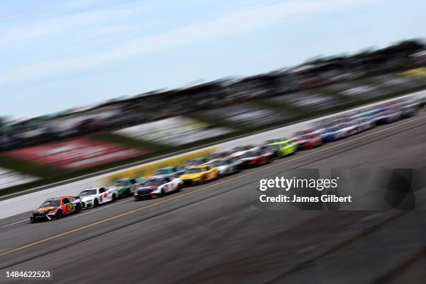 Martin Truex Jr., driver of the Bass Pro Shops Toyota, leads the field during the NASCAR Cup Series GEICO 500 at Talladega Superspeedway on April 23,...