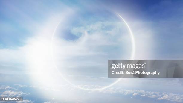 light effect similar to an eclypse above clouds in the sky (manipulated image) - god sky stock pictures, royalty-free photos & images