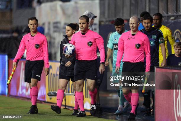 Assistant referee Kevin Klinger, referee Alex Chilowicz and assistant referee Jason White take the field during a match between Philadelphia Union...