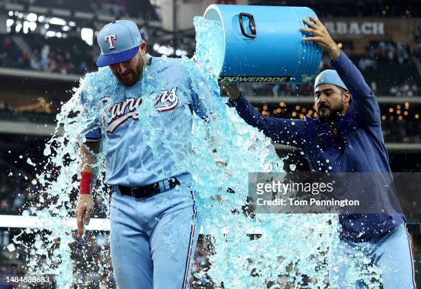 Robbie Grossman of the Texas Rangers is doused with Poweraid after beating the Oakland Athletics 5-2 at Globe Life Field on April 23, 2023 in...