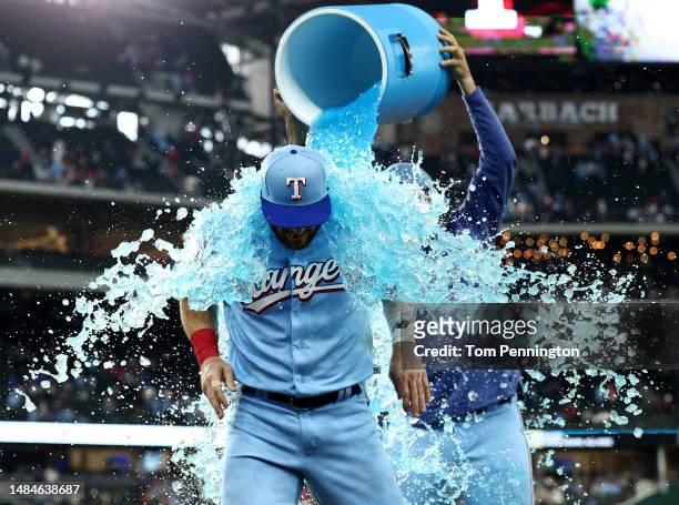 Robbie Grossman of the Texas Rangers is doused with Poweraid after beating the Oakland Athletics 5-2 at Globe Life Field on April 23, 2023 in...