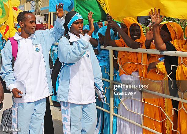 Athletes Mohamed Hassan Mohamed who will compete in the 1500m race and Zamzam Mahmuud Farah who will compete in the 800m race greet fans before...