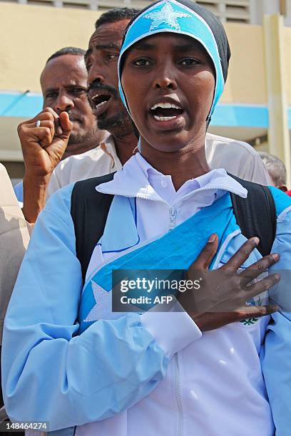 Athlete Zamzam Mahmuud Farah, who will compete in the 800m race, sings the national anthem before boarding an airplane to London to attend the 2012...