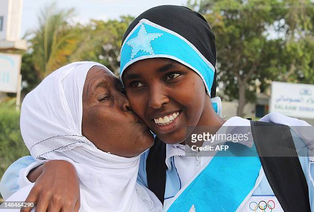 Zamzam Mahmuud Farah, who will compete in the 800m race, is given a kiss before boarding an airplane to London to attend the 2012 Olympic games, on...