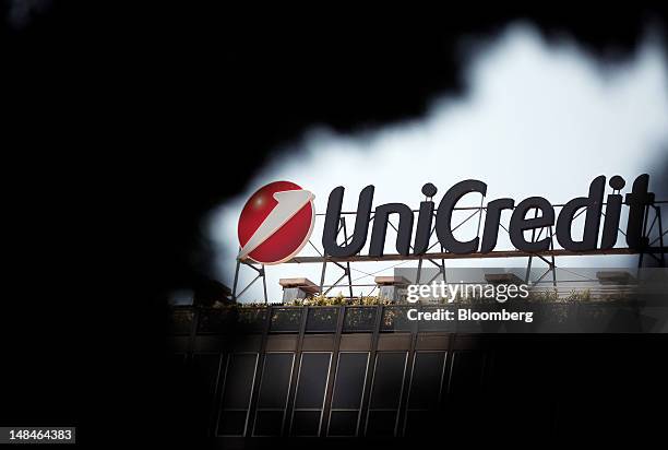 The UniCredit SpA logo sits on the roof of the company's headquarters in Rome, Italy, on Tuesday, July 17, 2012. UniCredit SpA and Intesa Sanpaolo...