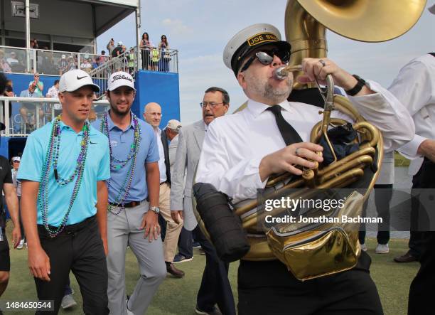 Nick Hardy of the United States and Davis Riley of the United States celebrate their win as they make their way to the 18th green for the trophy...